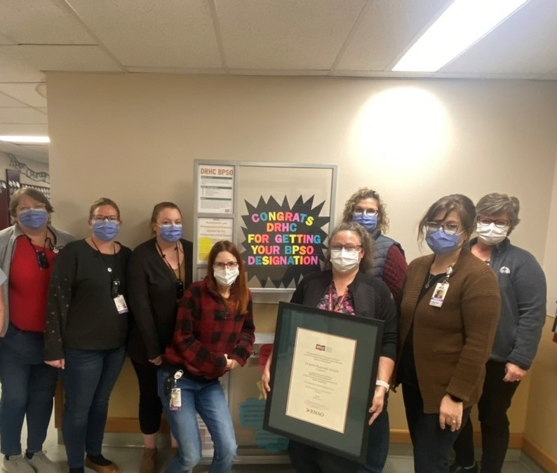 BPSO Project Teams pose with certficate of designation as a Best Practice Spotlight Organziation